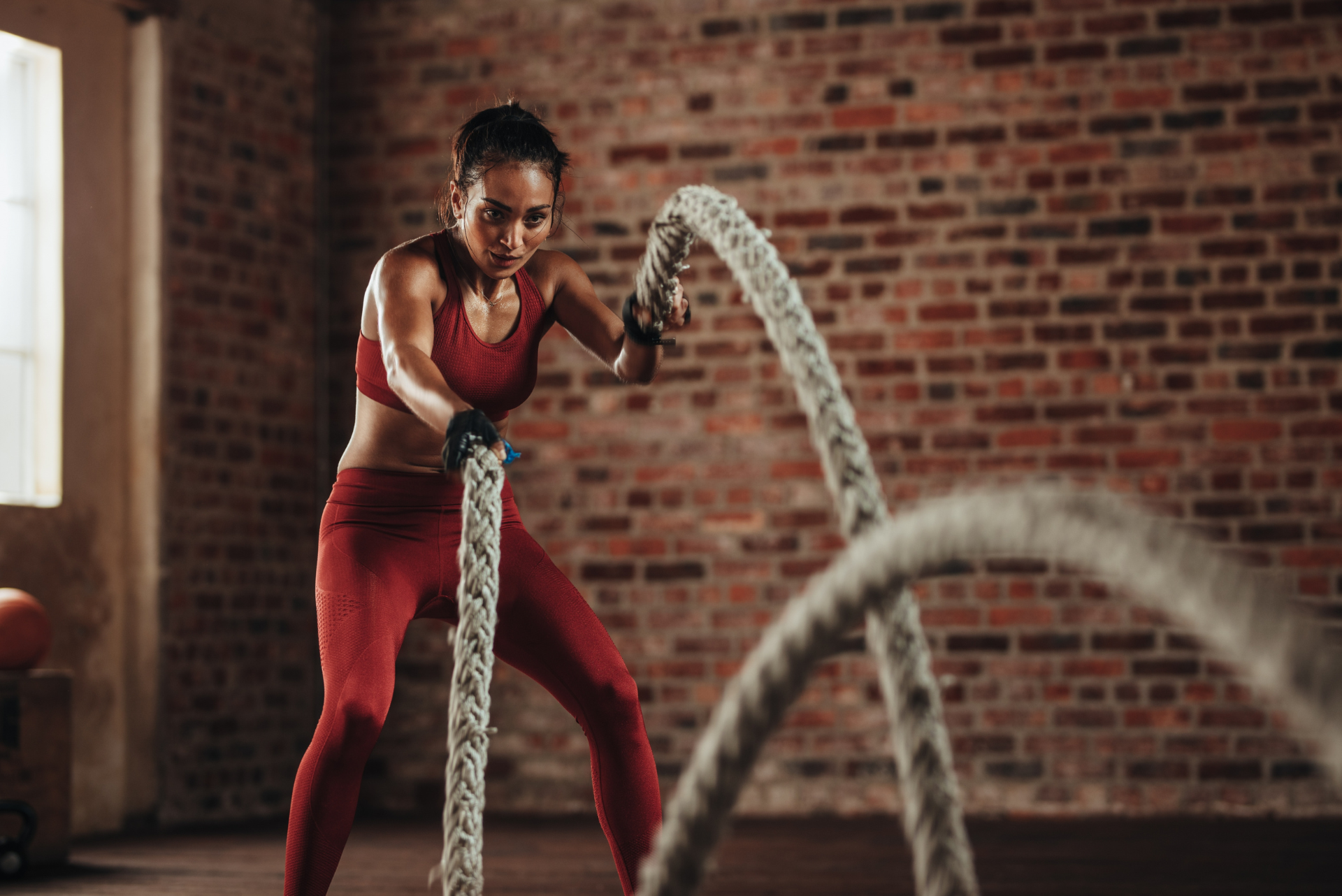 woman training on the ropes at the gym