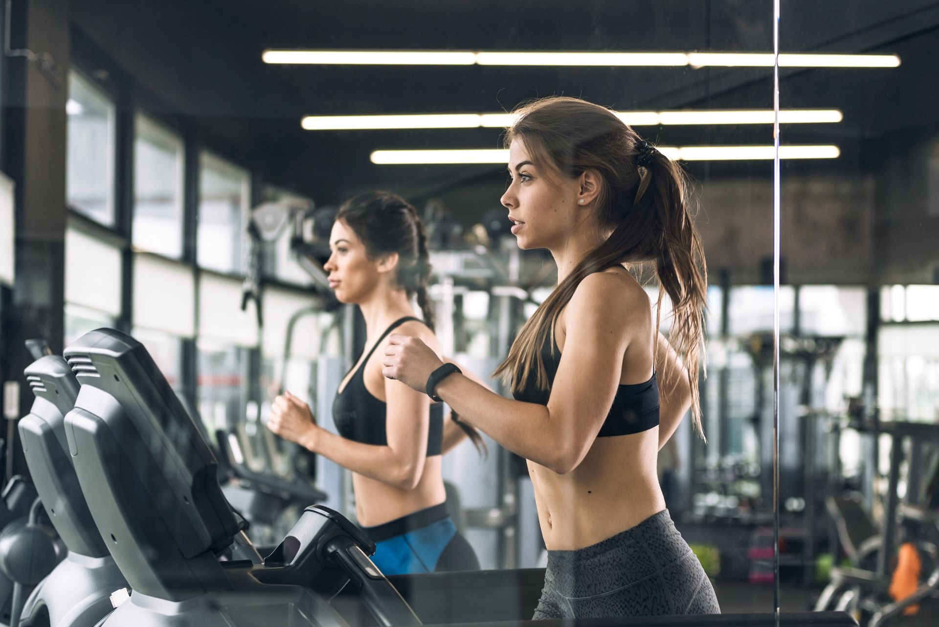 women on a treadmills on a gym 