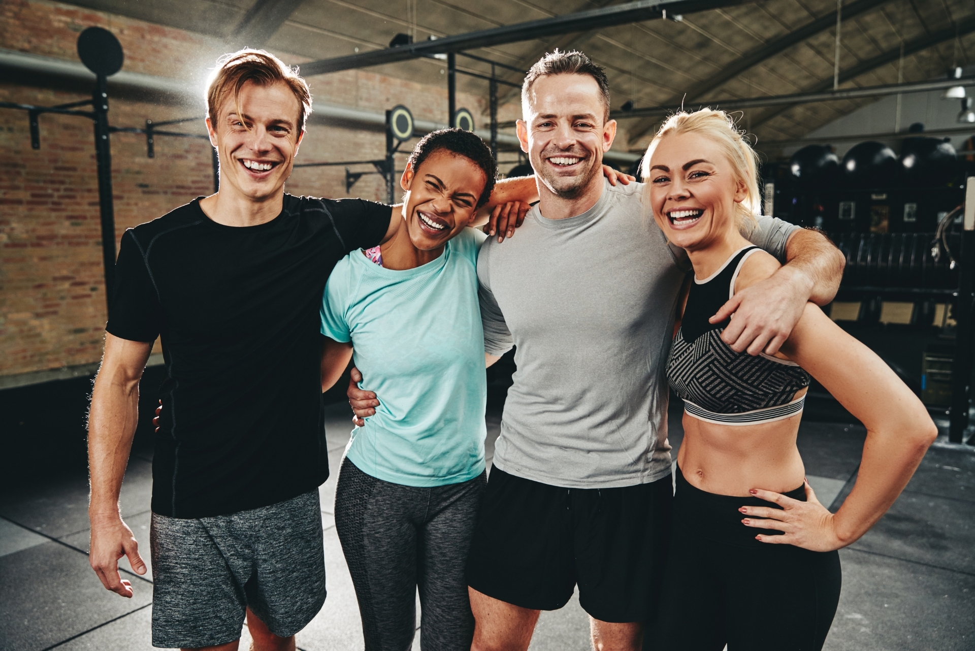 group of happy people at the gym