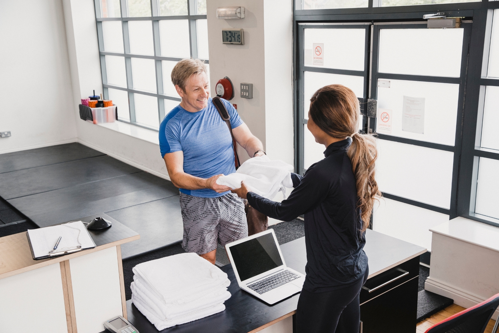 man and woman in the front desk at the gym