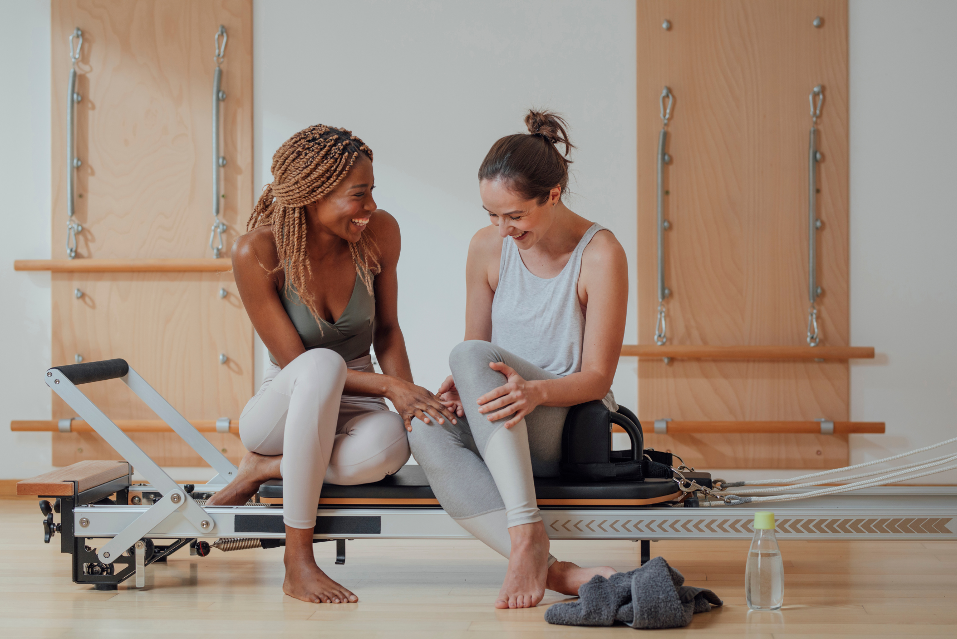 two women talking and laughing at the pilates class 