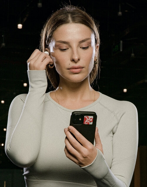 woman looking at smartphone at the gym