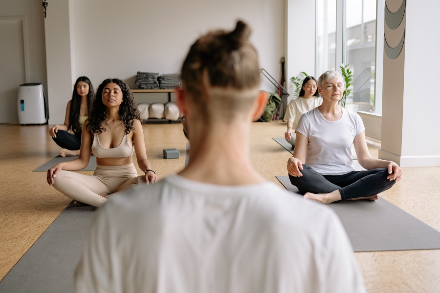 man standing in front of a group of people doing yoga