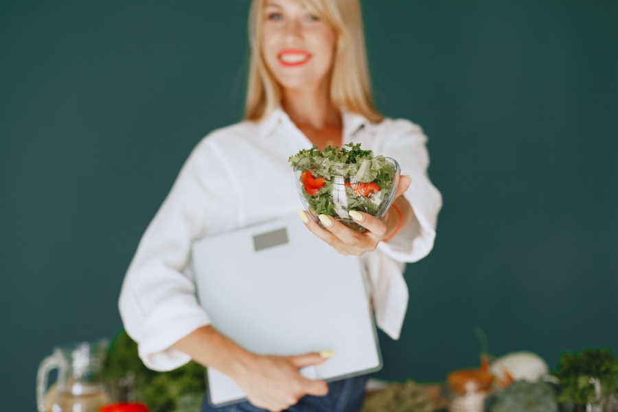 woman holding bowl with salad