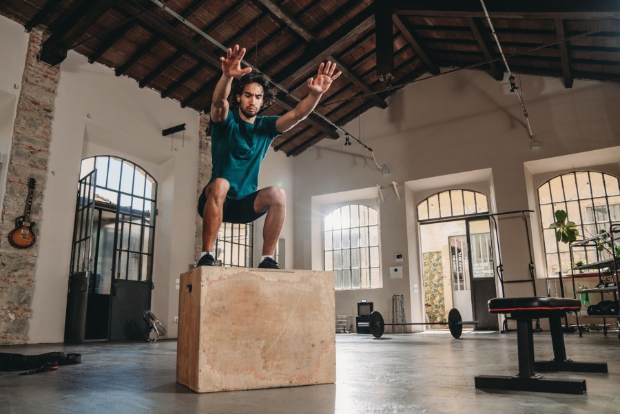 a man jumping on a box at the loft gym