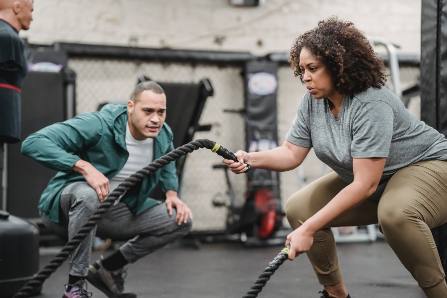 woman exercising with battle ropes
