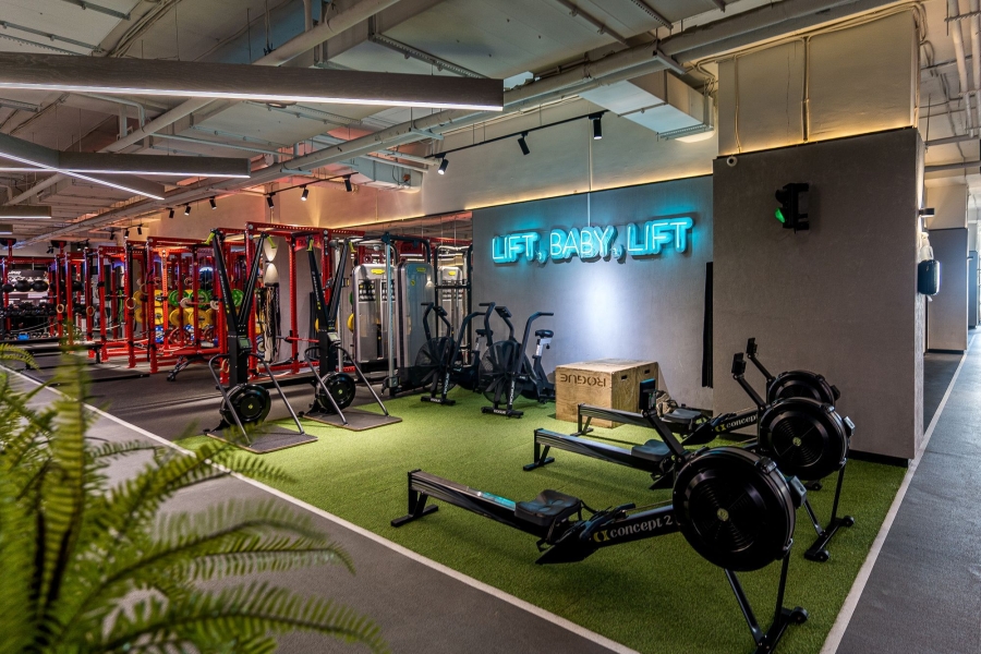gym interior with a blue neon sign on the wall 