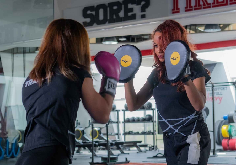 two woman boxing at the gym