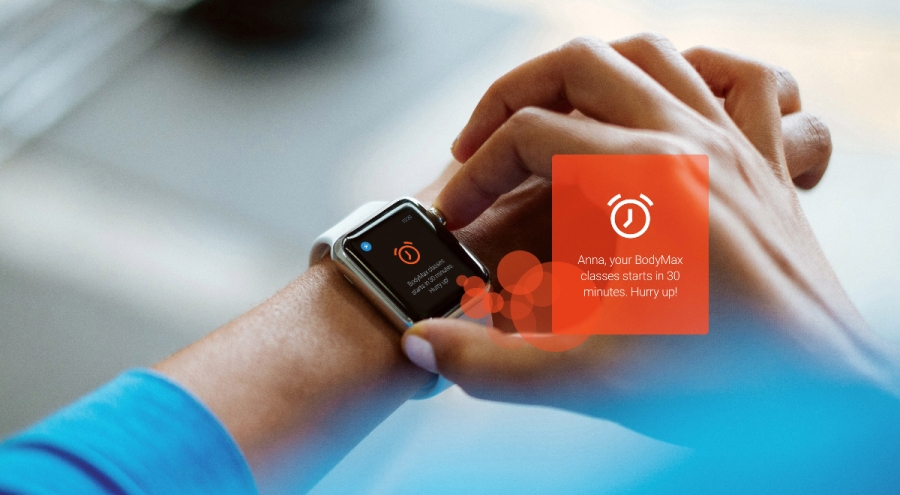 hands with smart watch showing the notification of upcoming classes