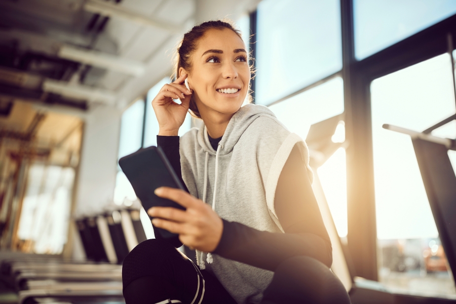 woman at the gym with mobile phone