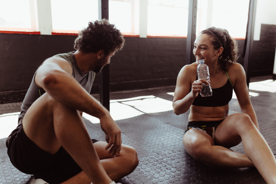 man and woman talking on a gym