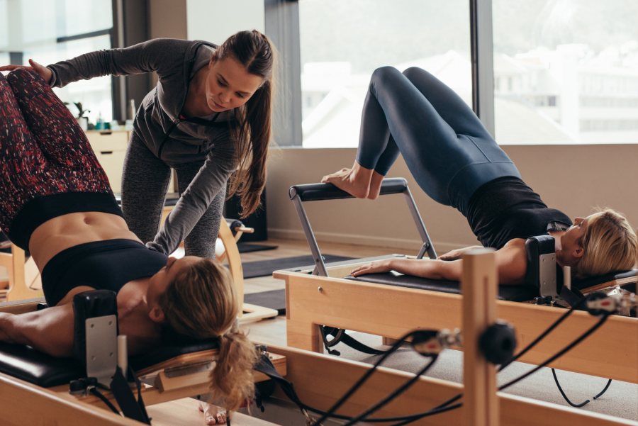 fitness instructor helping participants during a gym class