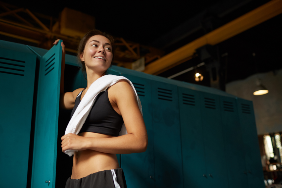 woman with a towel in gym locker room