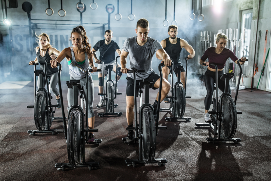 people working out on indoor bikes