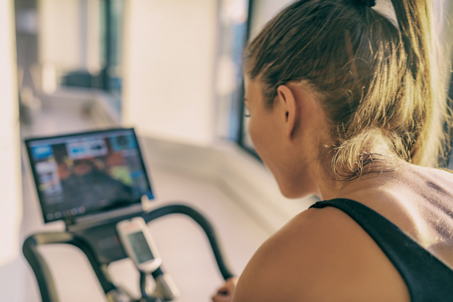 woman training on a modern stationary bike