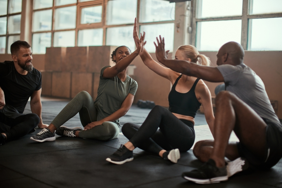 people giving high five at the gym