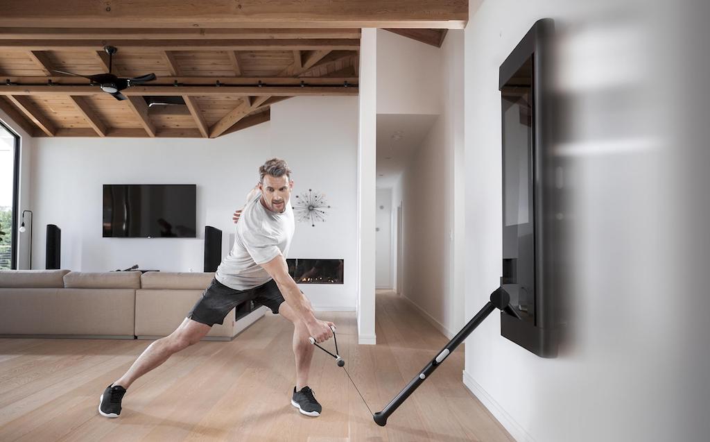 Man working out at home with Tonal strength machine